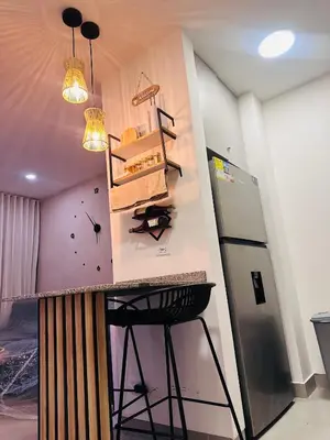 a kitchen with a counter top and a refrigerator at Nuevo Loft santa Marta vista al mar piso 18 in Santa Marta