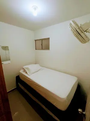 a small bedroom with a white bed in a room at Apartamento en Cartagena cerca al Mar in Cartagena de Indias