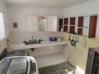 a small kitchen with a sink and a counter top at Entire house in Cartagena in Cartagena de Indias