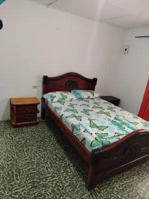 a bedroom with a bed and a table in a room at Entire house in Cartagena in Cartagena de Indias