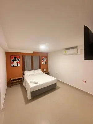 a bedroom with a bed and a flat screen tv at Hotel CARTAGENA ES in Cartagena de Indias