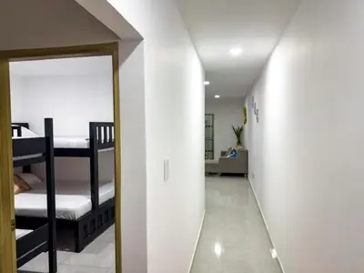 a hallway leading to a room with bunk beds at Apartamento coral del mar in Tolú