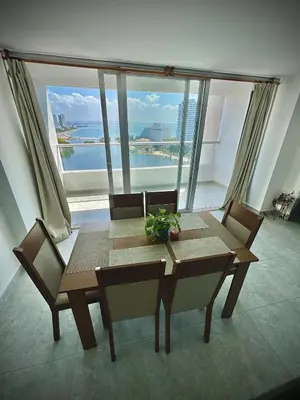 a table and chairs in a room with a large window at Vista soñada cerca al mar y centro histórico in Cartagena de Indias