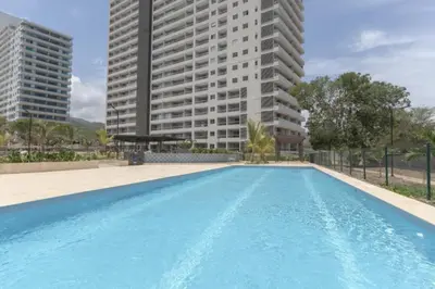 an empty swimming pool in front of two tall buildings at Apartamento en Santa Marina in Santa Marta