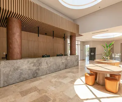 an office lobby with a table and chairs at Apartamento en Santa Marina in Santa Marta