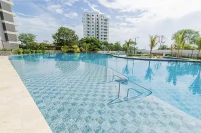a swimming pool with a sign in the water at Apartamento en Santa Marina in Santa Marta