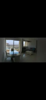 a view of a living room with a couch and a table at Apartamento entero en Miramar, Barranquilla Norte in Barranquilla