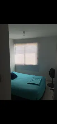a bedroom with a blue bed and a window at Apartamento entero en Miramar, Barranquilla Norte in Barranquilla