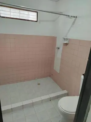 a bathroom with a pink tiled shower with a toilet at Cartagena, full house in Cartagena de Indias