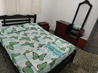 a bed with a quilt with butterflies on it at Cartagena, full house in Cartagena de Indias
