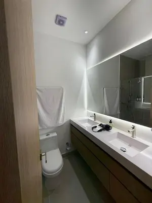 a bathroom with a toilet and a sink and a mirror at Luxy 2BR at paradise Oasis, 18 min from walled city in Cartagena de Indias