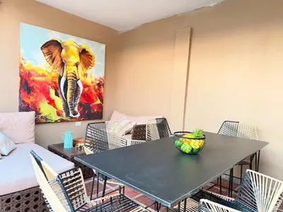 a dining room with a table and a painting of an elephant at Casa Mercedes Cartagena in Cartagena de Indias