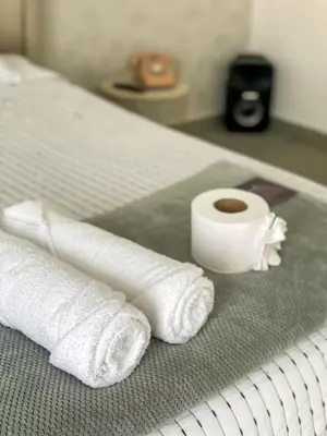 a pile of towels and a cup of coffee on a bed at Tu Espacio Perfecto en el Norte de Barranquilla - Moderno y Amplio - Apto Dúplex in Barranquilla