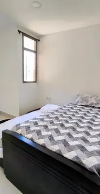 a bedroom with a bed with a quilt on it at Brisa y Rio Apartamento en Norte Centro historico in Barranquilla