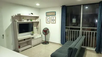 a living room with a couch and a television at Apartamento Hermoso in Barranquilla