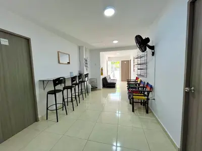 a hallway with chairs and a bar in a house at Habitación con baño privado cerca del carnaval de Barranquilla in Barranquilla