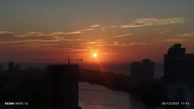 a sunset over a city with a river and buildings at Apartamento en cartagena vista al mar in Cartagena de Indias