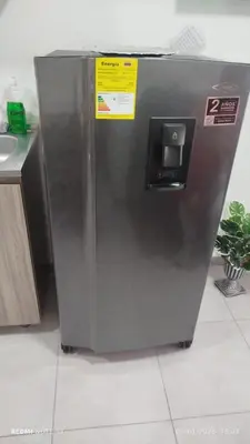 a stainless steel refrigerator with two signs on it at Apartamento en cartagena vista al mar in Cartagena de Indias