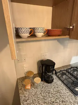 a kitchen counter with two cups and a coffee maker at Charming Apartment Close to the Beach in Cartagena de Indias