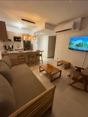 a living room with a couch and a table at Charming Apartment Close to the Beach in Cartagena de Indias