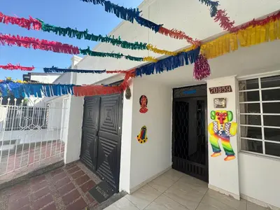 a house with colorful garland on the wall and two doors at The best room in Barranquilla! in Barranquilla