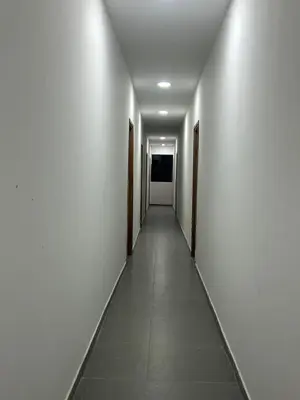 an empty corridor with white walls and a long hallway at Hotel Porton De La Sabana in San Onofre