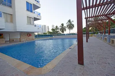 a swimming pool in front of a building at Apartamento con vista al mar - Riviera Mulata Beach in Cartagena de Indias