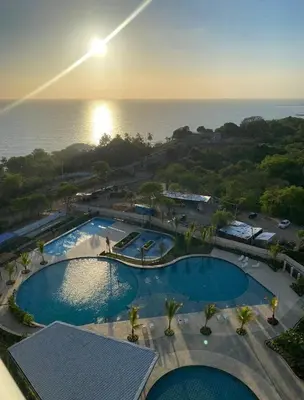 an overhead view of a swimming pool near the ocean at New apartment on the 18th floor in Santa Marta with ocean views in Simón Bolivar