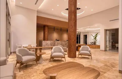 a lobby with a table and chairs and a counter at New apartment on the 18th floor in Santa Marta with ocean views in Simón Bolivar