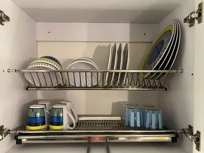 a kitchen with plates and dishes on a shelf at Ocean Blue Apartment WiFI Beach Old Town in Cartagena de Indias