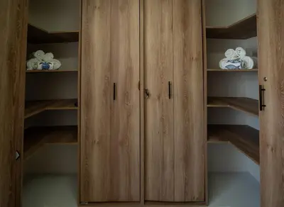 a closet with wooden cabinets and dishes in it at Ocean Blue Apartment WiFI Beach Old Town in Cartagena de Indias