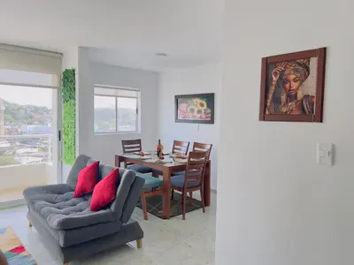 a living room with a couch and a table at Beach 1203 Lotus Cartagena in Cartagena de Indias