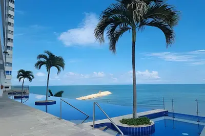 a view of the beach from a balcony with palm trees at Ocean View Loft Altamar in Cartagena de Indias
