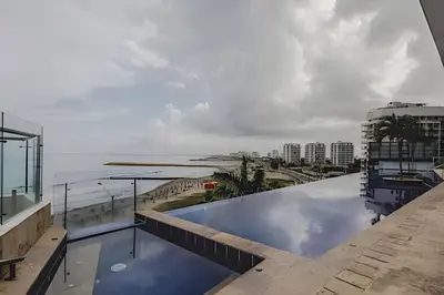 a pool on the roof of a building with a view of the ocean at Ocean View Loft Altamar in Cartagena de Indias