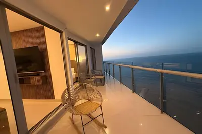 a balcony with a chair and a view of the ocean at Ocean View Loft Altamar in Cartagena de Indias