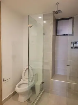 a bathroom with a toilet and a glass shower at Apartamento in Morros Eos-Manzanillo del Mar in Cartagena de Indias