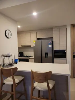 a kitchen with a counter with two chairs and a refrigerator at Apartamento in Morros Eos-Manzanillo del Mar in Cartagena de Indias
