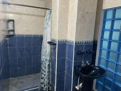 a bathroom with a toilet and a sink and a shower at Delfines De Bocagrande in Cartagena de Indias