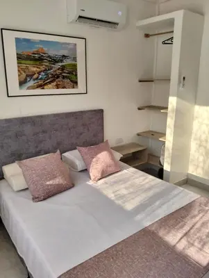 a bedroom with a bed with two pillows on it at Sandymar in San Bernardo del Viento