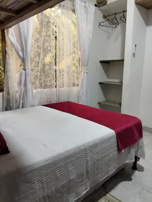 a bed in a room with a window at Sandymar in San Bernardo del Viento