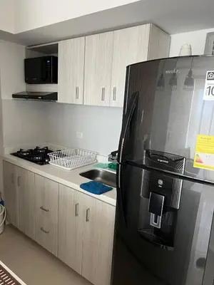 a kitchen with a black refrigerator and a sink at Spacious Flat with stunning Views Great Location in Cartagena de Indias