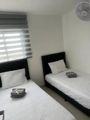 two beds sitting next to each other in a bedroom at Spacious Flat with stunning Views Great Location in Cartagena de Indias