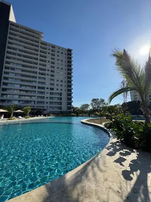 a large swimming pool next to a tall building at Santa Marina Caribbean Dreams in Santa Marta