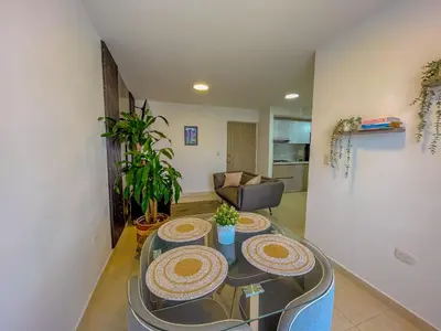a living room with a table with plates on it at View 17, Modern, 5 min from Rafael Nuñez Airport in Cartagena de Indias