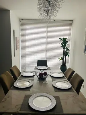 a dining room table with chairs and plates on it at Luxury Apartment in Great Area! in Barranquilla
