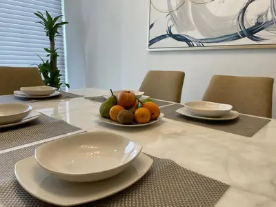 a table with plates and bowls of fruit on it at Luxury Apartment in Great Area! in Barranquilla