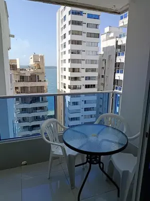 a table and chairs on a balcony with a view of the ocean at Estudio piso 9 APTO 909 in Cartagena de Indias