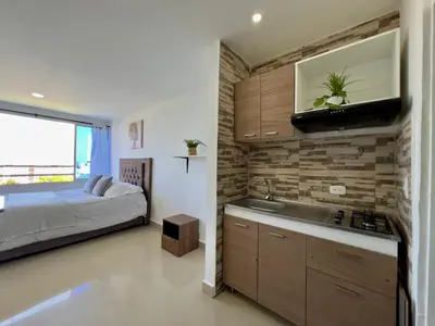 a kitchen with a sink and a bed in a room at Riviera Mulata Loft - Apartamento con vista al mar in Cartagena de Indias