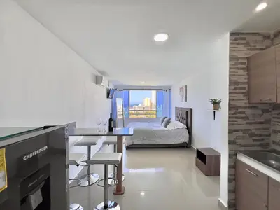 a kitchen and living room with a bed in the background at Riviera Mulata Loft - Apartamento con vista al mar in Cartagena de Indias