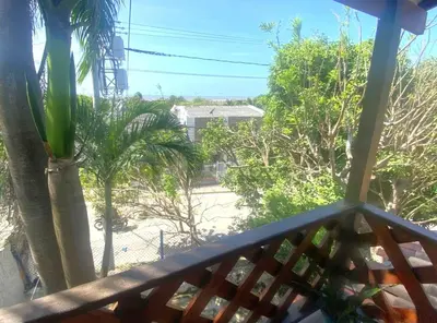 a view from the balcony of a house with palm trees at Apartaestudio con balcón cerca al mar in Puerto Colombia
